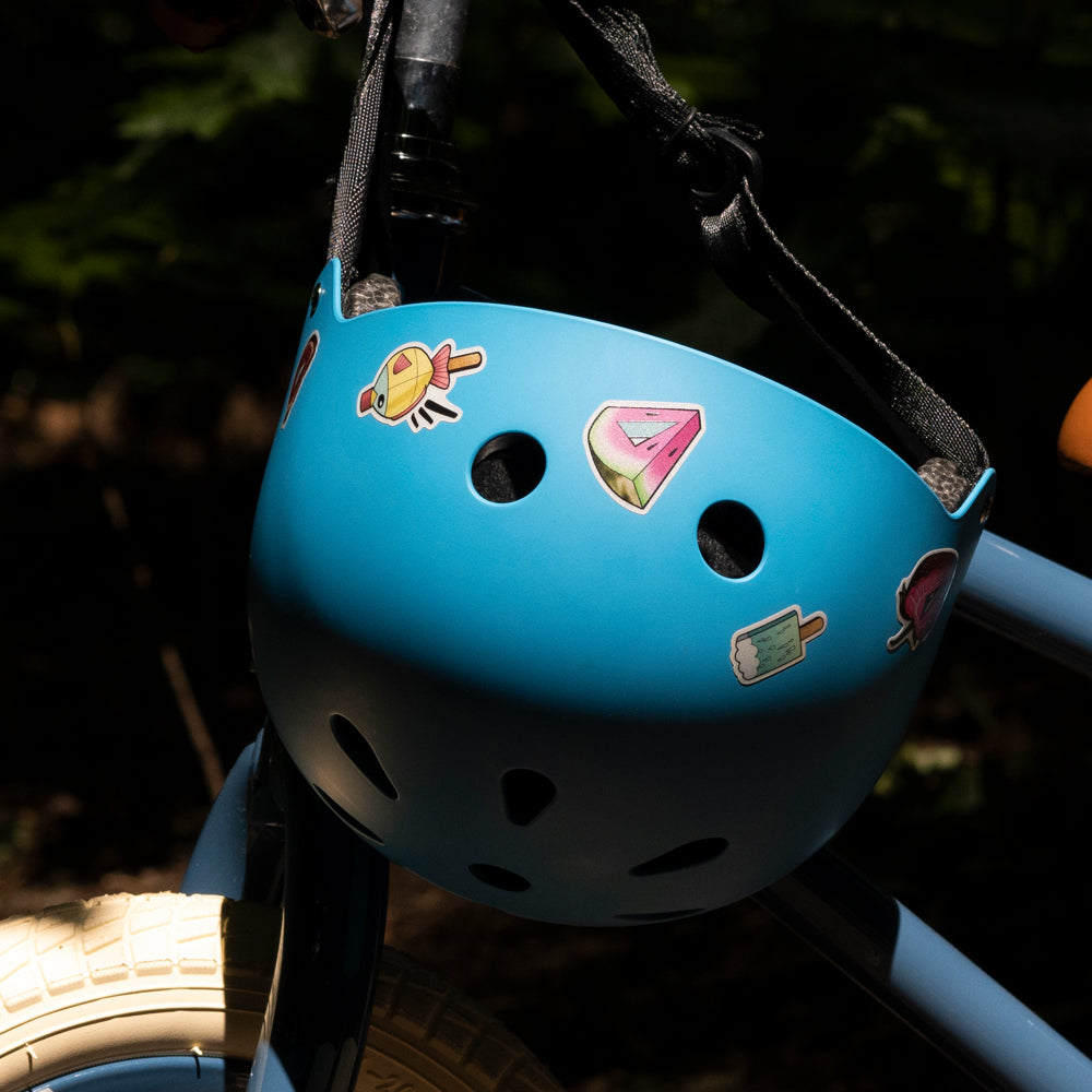 helmet hanging on bike handlebar, with reflective stickers
