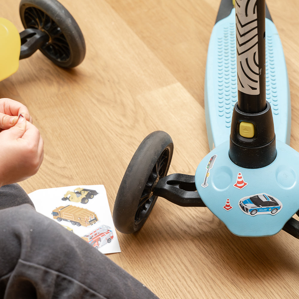 Applying reflective stickers to a scooter with wooden floor