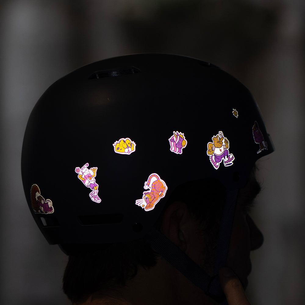 Reflective sticker design from artist C. Miller on helmet at night