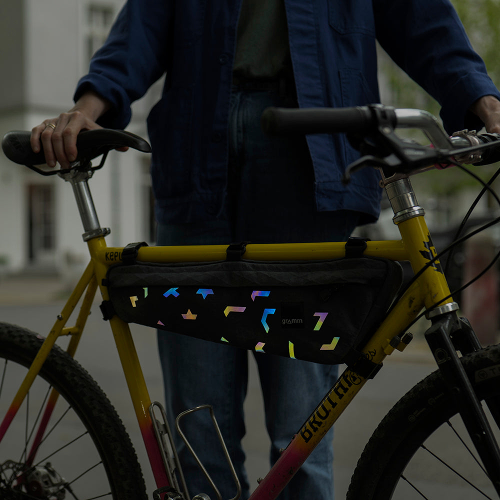 rainbow reflective stickers on bicycle bag, with blurry background