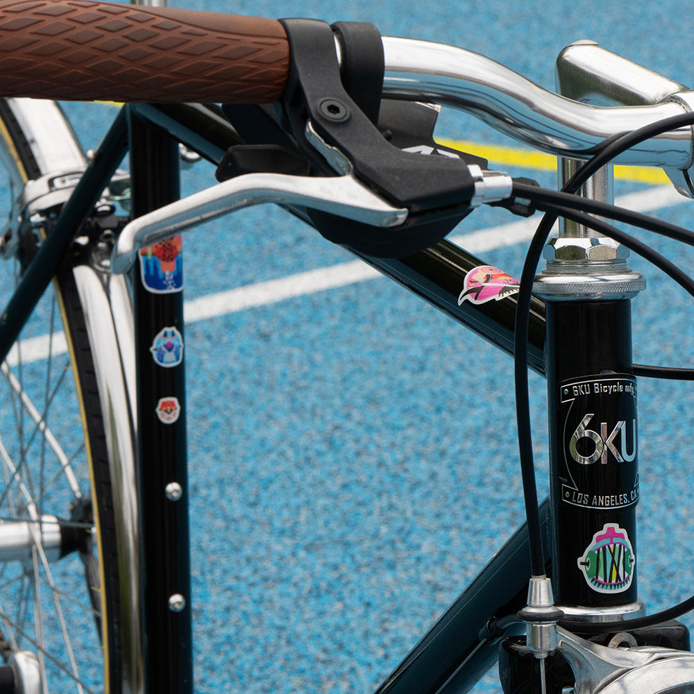 Bicycle frame with Kurihara stickers and blue background 