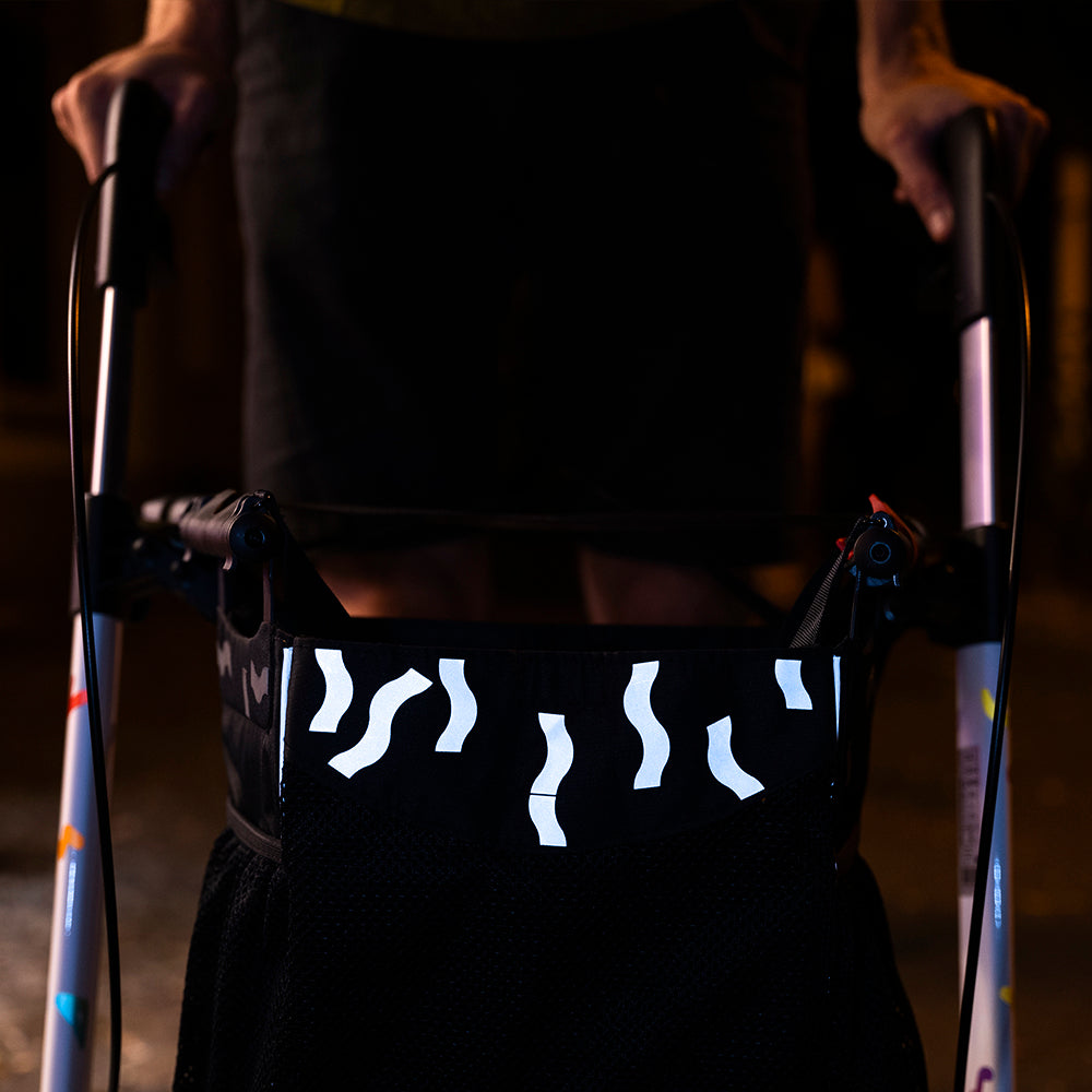 Reflective textile stickers applied on rollator in front bag at night