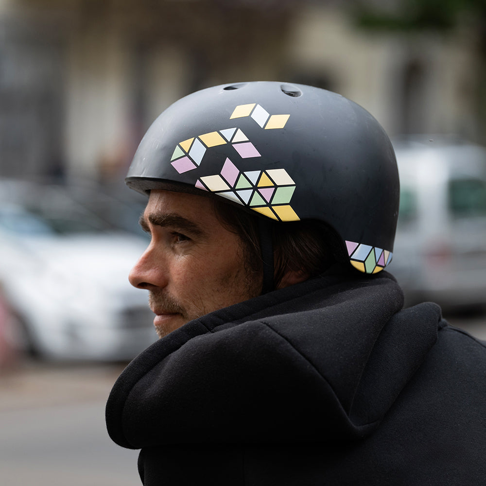 man wearing helmet looking left before crossing